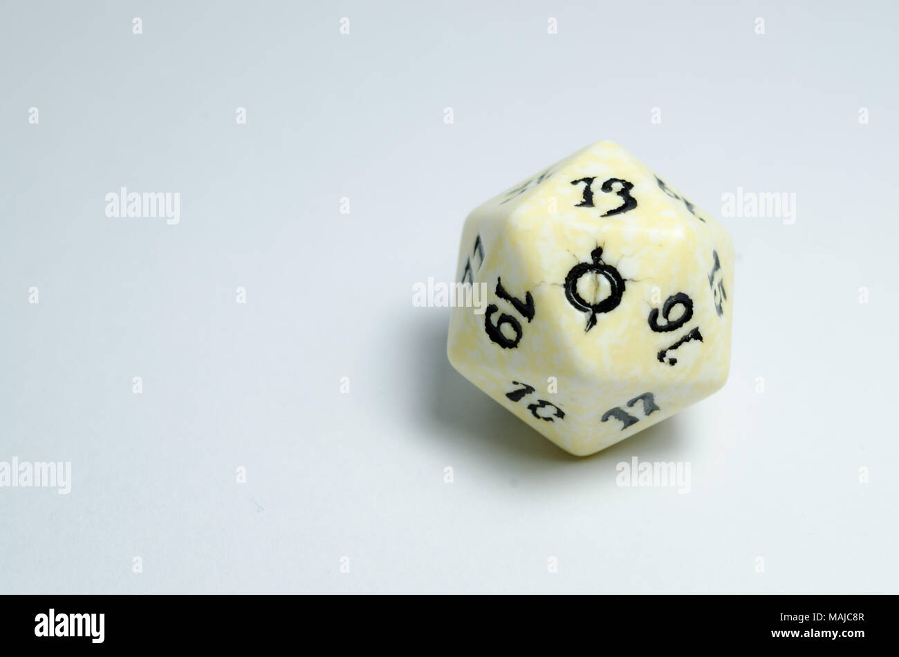 twenty-sided dice, isolated on a white background. symbol in focus. dice of role playing game Stock Photo