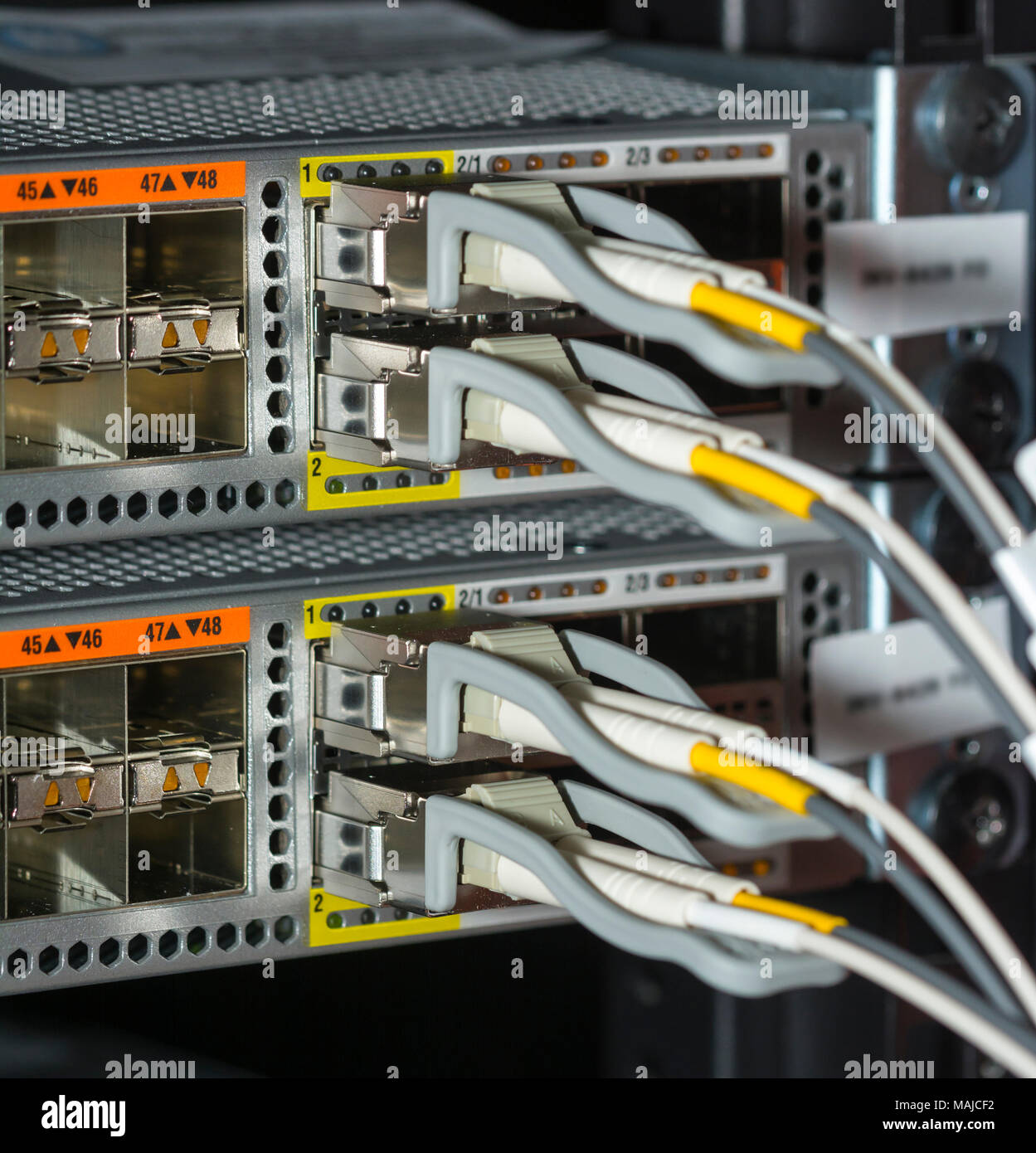 Network cables and servers in a technology data center  Network cables in switch Stock Photo