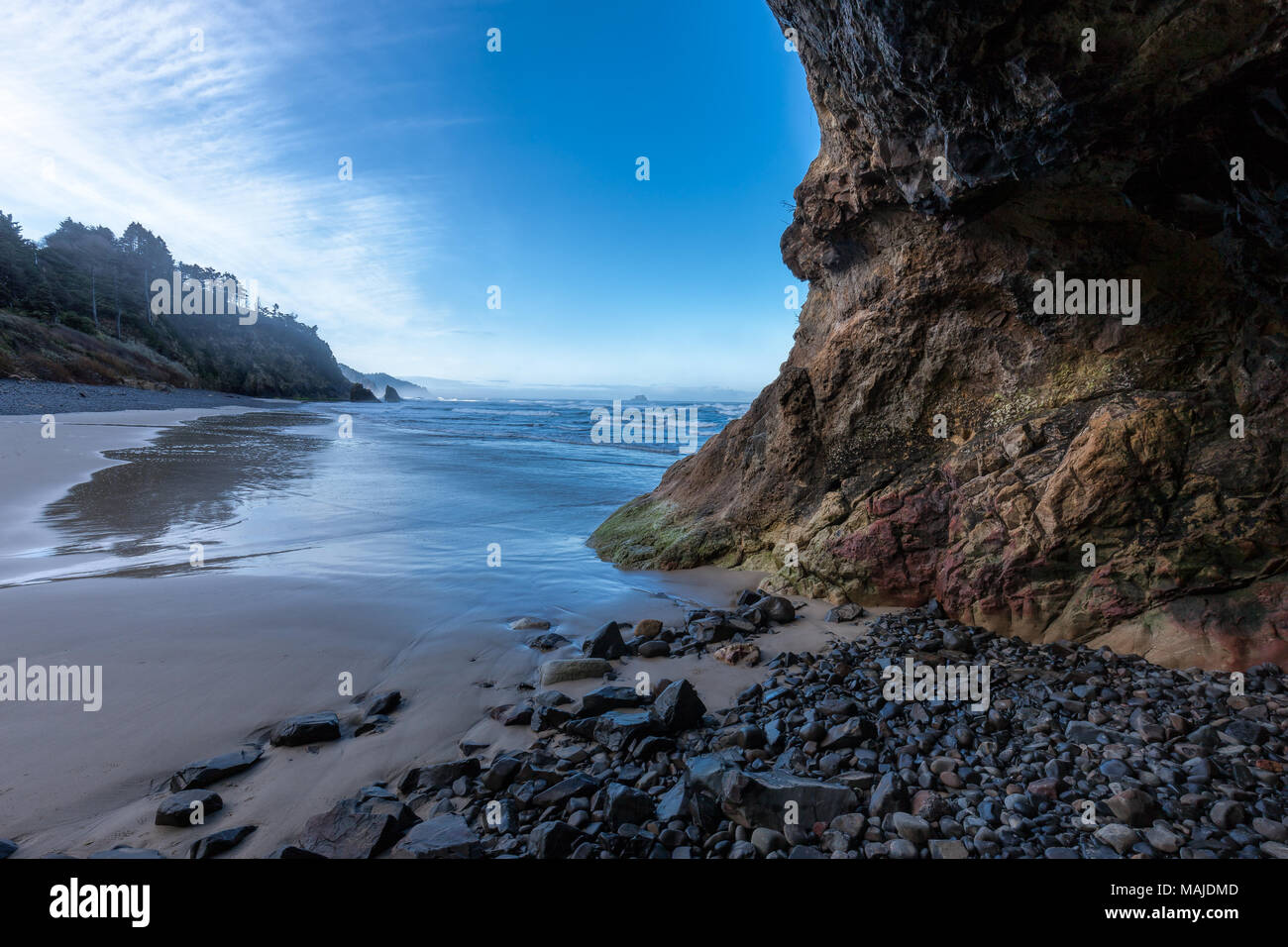 Looking out from a small cave at the ocean on Hug Point Beach in northern Oregon. Stock Photo