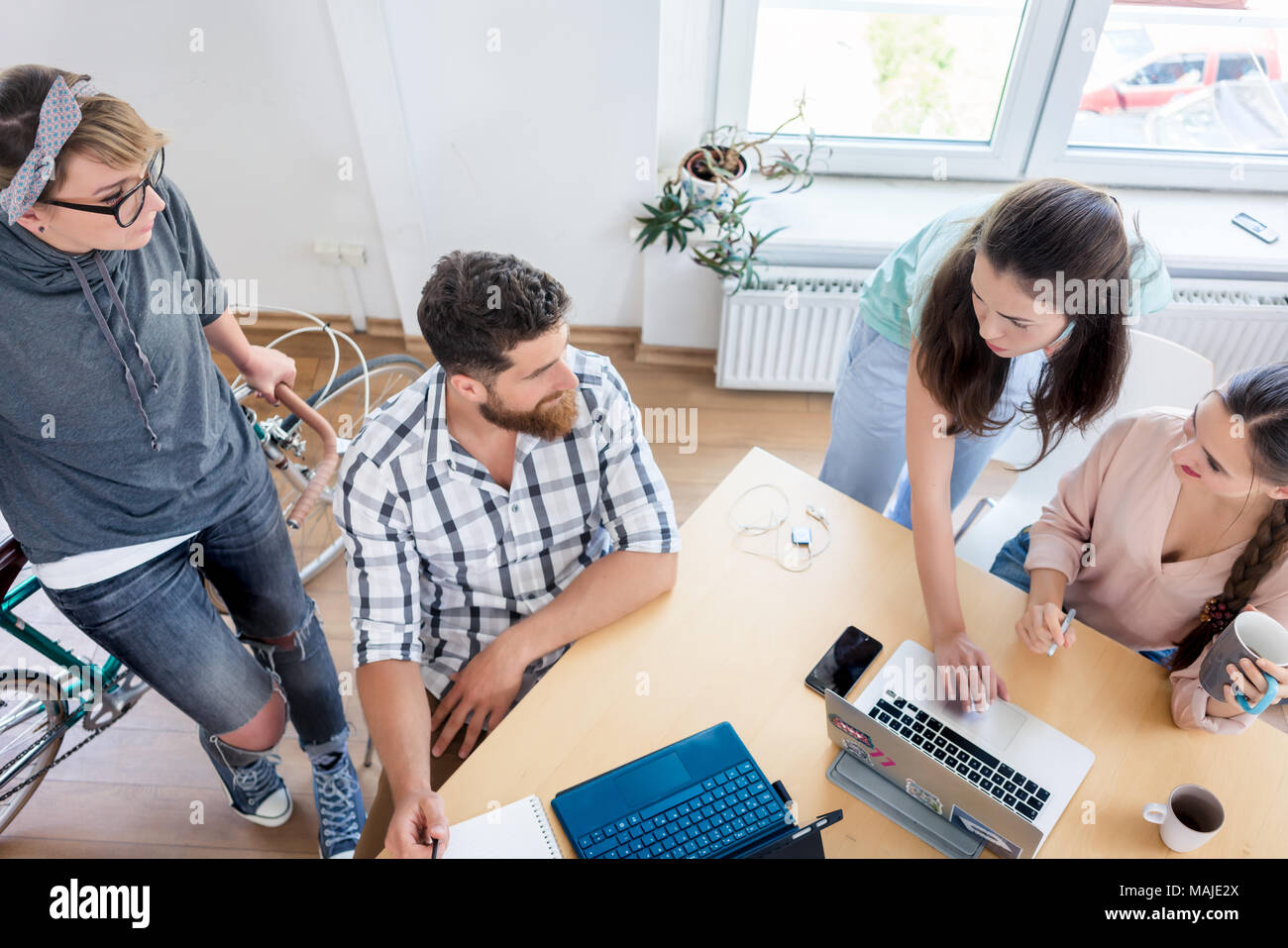 Young co-workers cooperating while working as freelancers Stock Photo