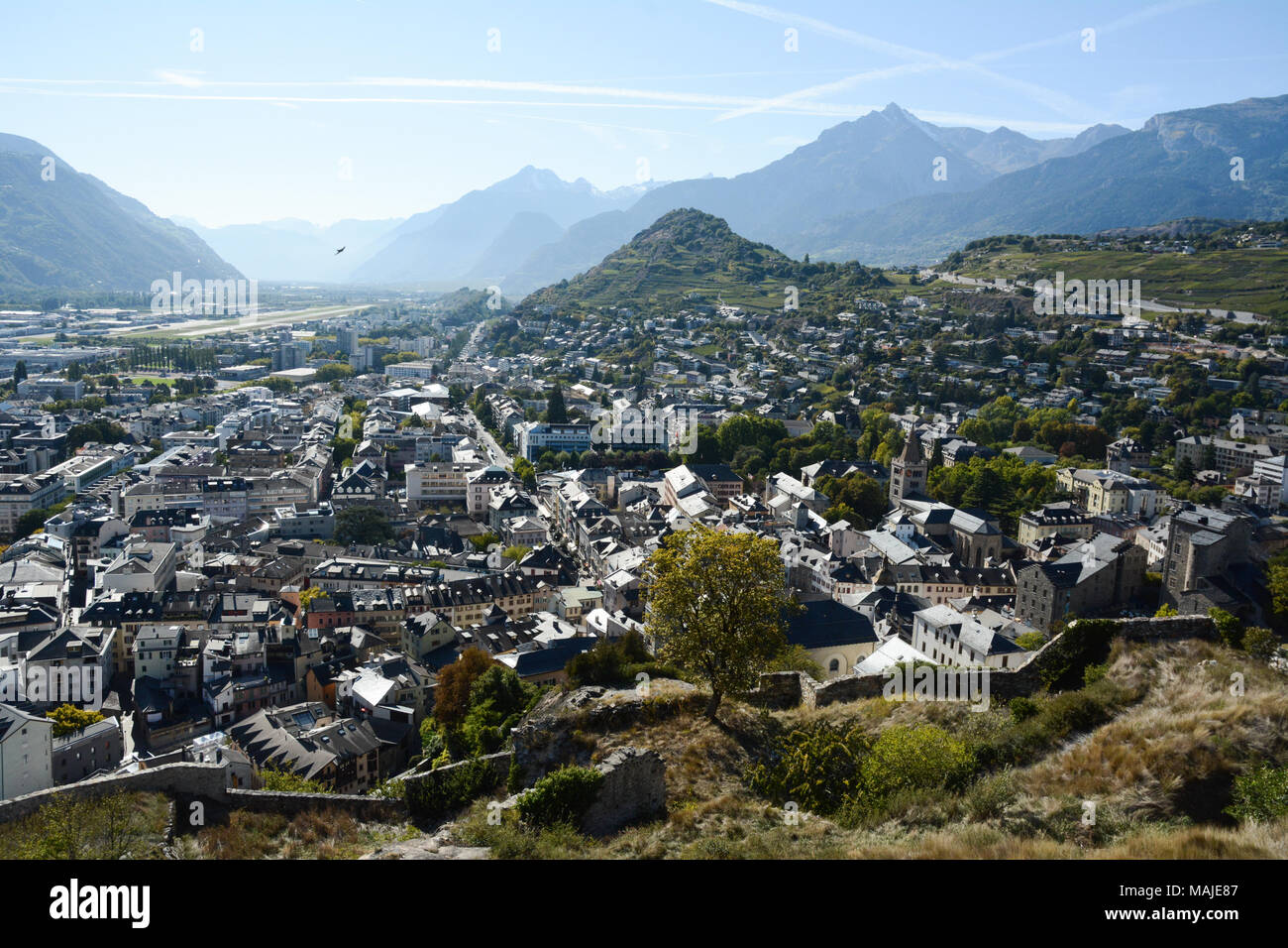 A view of the Swiss city of SIon, seen from the hilltop Basilique Notre Dame de Valère, in the upper Rhone Valley, canton of Valais, Switzerland. Stock Photo