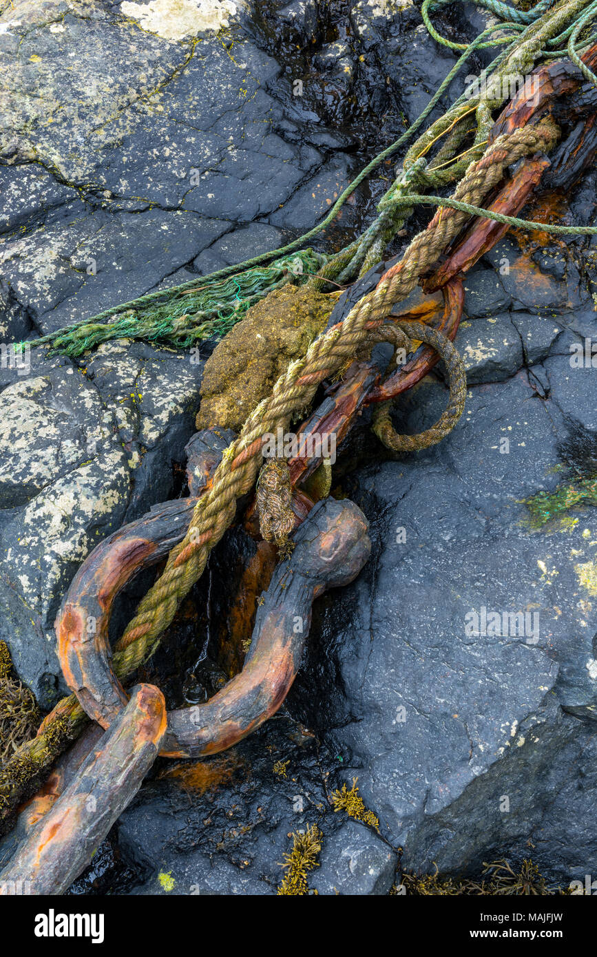a rusty and corroded old nautical shackle and maritime mooring chain. nautical items and weather worm berthing and mooring ropes, wires and tackles. Stock Photo