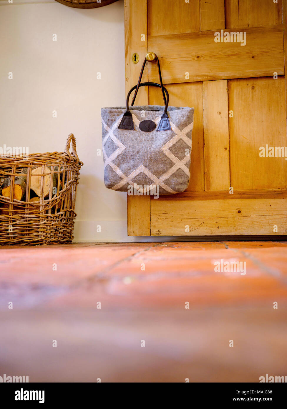 A handbag hanging on a door handle at a home in West Sussex, UK. Stock Photo