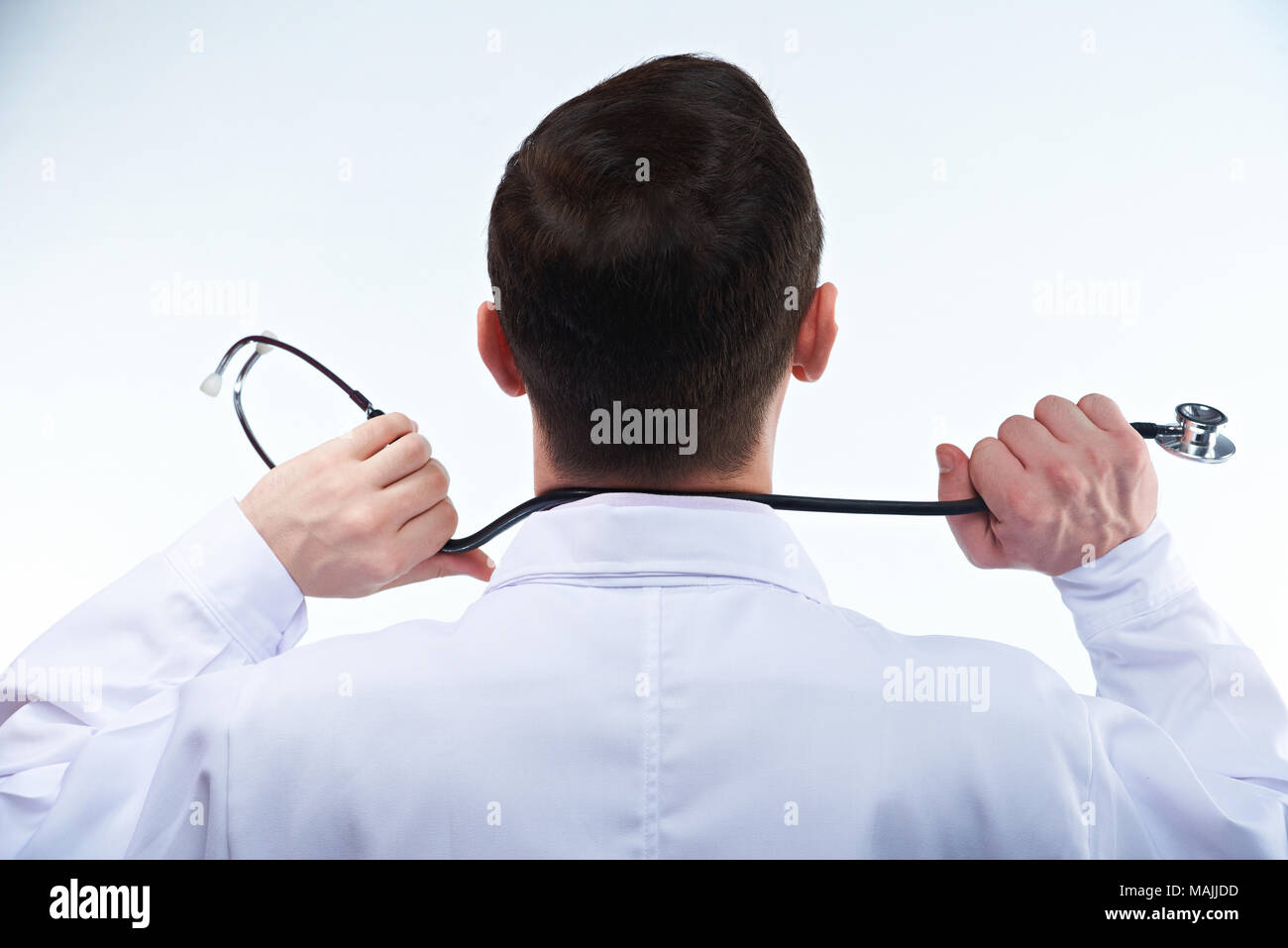 Young man doctor with stethoscope view from back isolated on white background Stock Photo