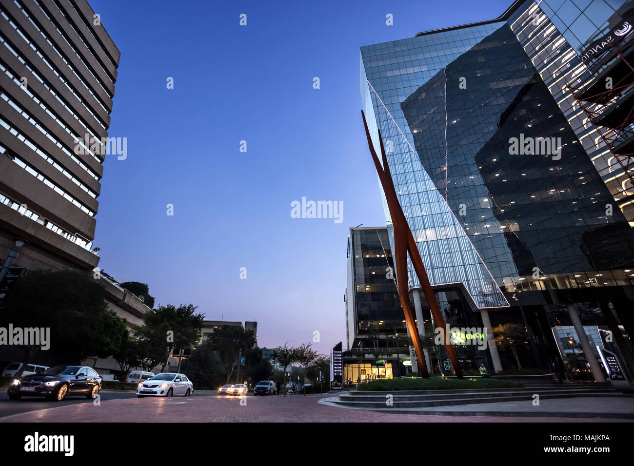 Johannesburg, South Africa, March 29-2018: Street scene with modern buildings in evening light. Stock Photo