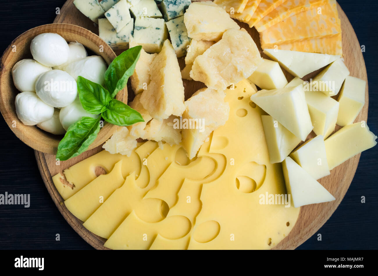 Cheese plate: Parmesan, cheddar, gouda, mozzarella and other with basil ...