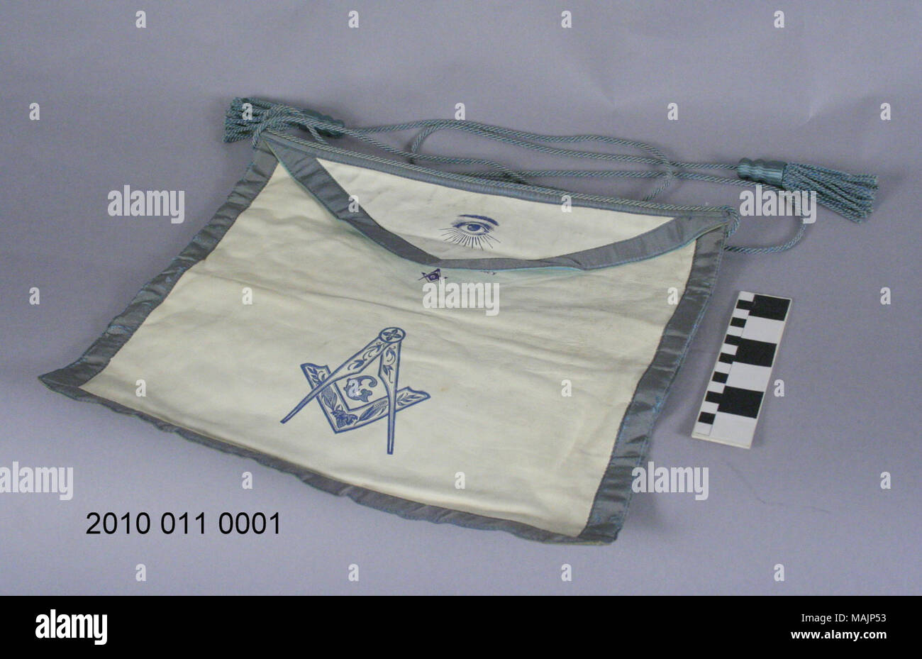 White leather Masonic apron with blue accents around edges. Blue cord