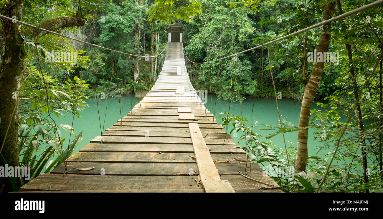 Hanging bridge over river in jungle of Rio Blanco National Park in ...