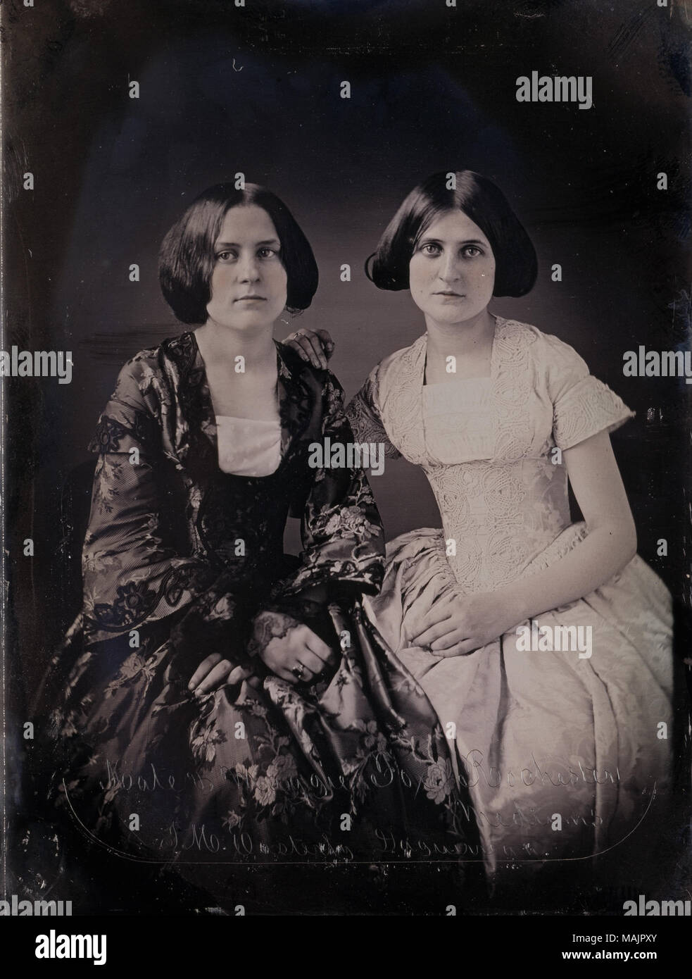 Portrait of Kate and Maggie Fox, Spirit Mediums from Rochester, New York. Along the bottom edge of the daguerreotype 'Kate and Maggie Fox, Rochester Mediums, T.M. Easterly Daguerrean' is inscribed. Portions of the daguerreotype are colored with pink pigment. Title: Kate and Maggie Fox, Spirit Mediums from Rochester, New York.  . 1852. Thomas M. Easterly Stock Photo