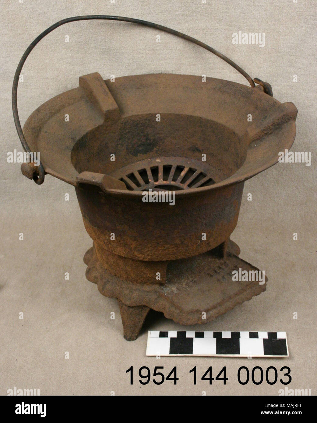 Cast iron charcoal brazier with bail handle manufactured by G.F. Filley. Title: Iron Charcoal Brazier Manufactured by G.F. Filley.  . circa 1851. Excelsior Stove and Manufacturing Co. Stock Photo