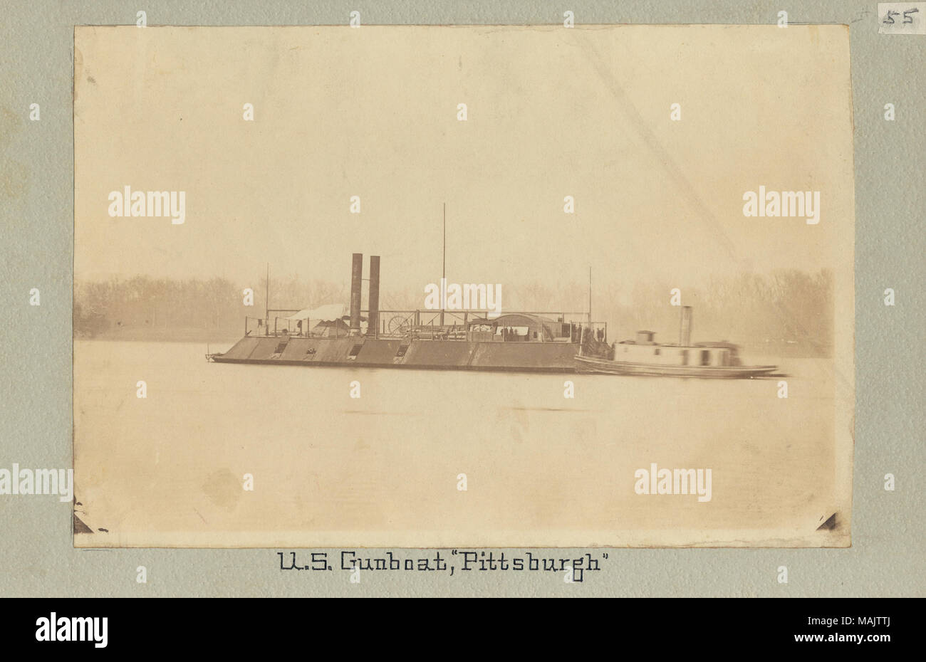 Photograph of an ironclad gunboat with twin stacks and four gun ports visible on port side. There is a smaller vessel behind the Pittsburg. 'U. S. Gunboat, 'Pittsburg'' (written below image). 'Gunboats # 55 Pittsburg Gift of John and Lewis Eads How' (written on reverse side). Eads' gunboat built in Carondelet, Missouri. Sister boat of the St. Louis, Louisville, and Carondelet. Title: U.S.S. Pittsburg.  . between 1861 and 1865. Stock Photo
