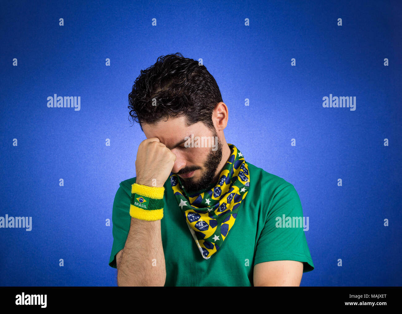 Soccer fan in action emotions depressed, worried. Supporter of Brazil