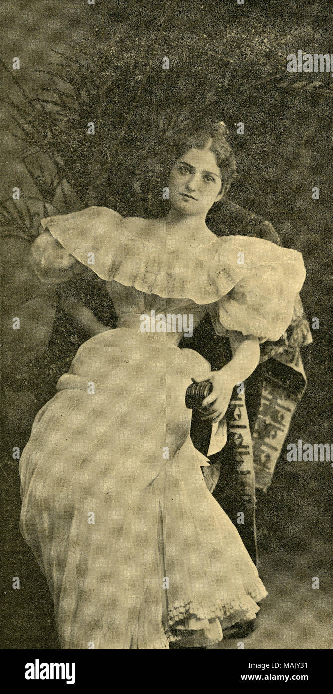 Mrs. Sylvester Scovell, born Frances Cabanne, ca 1917, leaning back in a chair, wearing a light colored dress with portrait collar and large puffed sleeves, tiny waist and full skirt with ruffled bottom.Her hair is done up in a bun and center part. Taken from a page of 'St. Louis Life'. Title: Frances Cabanne (Mrs. Sylvester Scovell).  . 1917. Stock Photo
