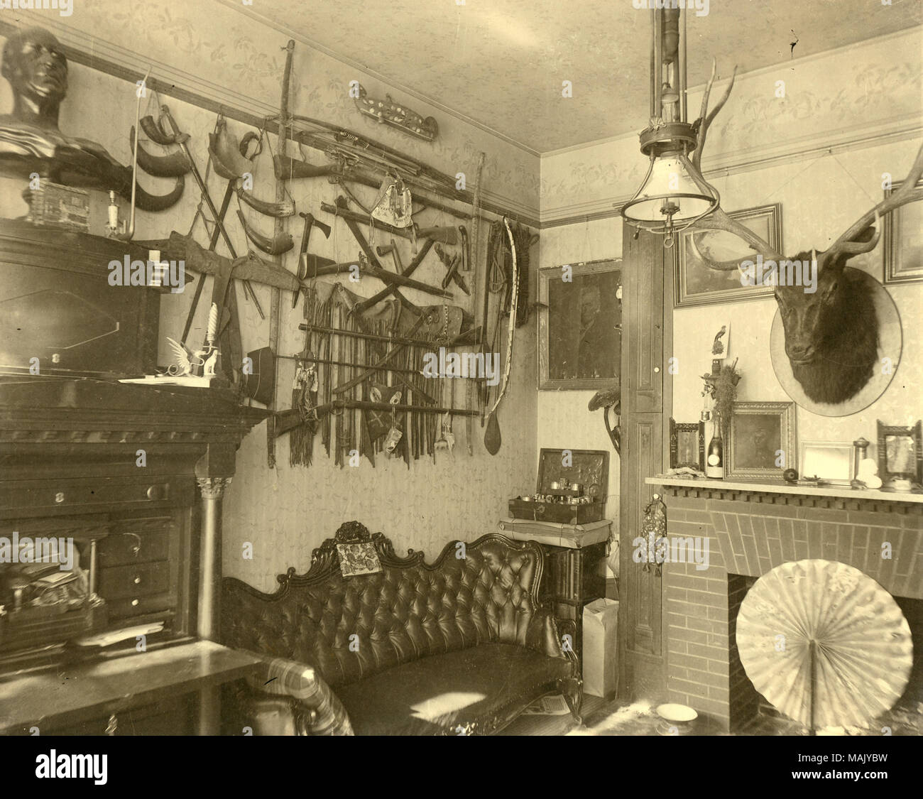 Title: [William Clark's Living Room] Parlor at Jefferson Kearney Clark Residence, 'Minoma' with souvenirs of William Clark's career and travels.  . circa 1890. Stock Photo