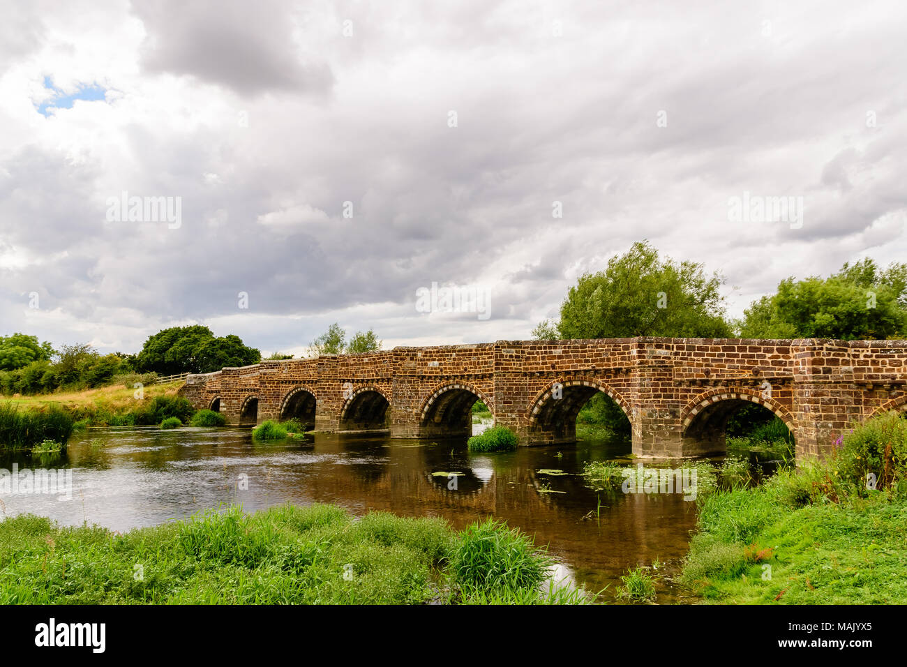 The Norman White Mill Bridge over the River Stour in Dorset, England.  Probably the oldest bridge to cross the Stour. Stock Photo