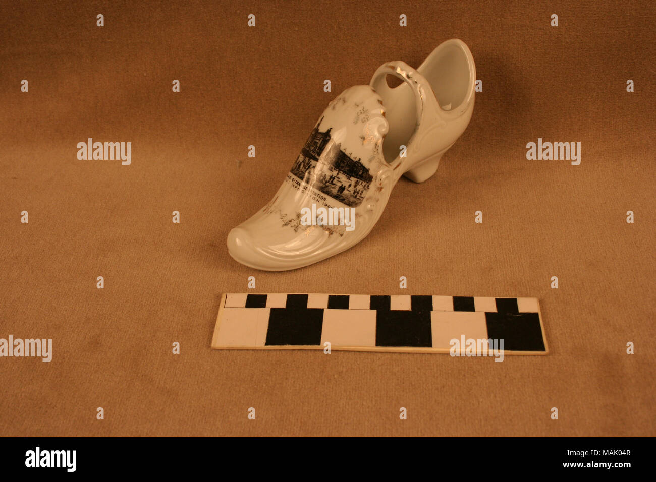 Large white ceramic ladies shoe has strap and gilt decoration surrounding a  black transfer image of the Palace of Transportation from the 1904 World's  Fair. Title: Large White Ceramic Ladies Shoe With, image size:1300x956