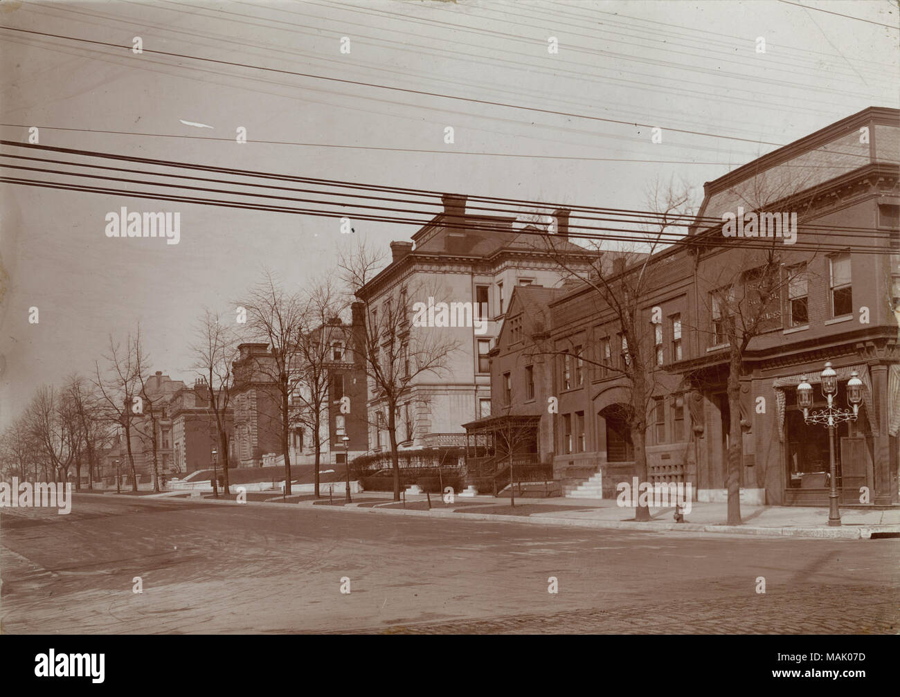 Residences at the northwest corner of Grand Avenue and Lindell Boulevard in 1910. The Berlitz School of Languages is at the northwest corner of the intersection. The first Berlitz School of Languages was opened in 1878 by Professor Maximilian. D. Berlitz. It was touted as the simplest and most efficient method for learning language, employing a total emersion method within its walls. By 1947 it is estimated that the school had 25,000 students a year and grossed $4,000,000 in revenue. Title: Northwest corner of Grand Avenue and Lindell Boulevard.  . 1910. Oscar C. Kuehn Stock Photo