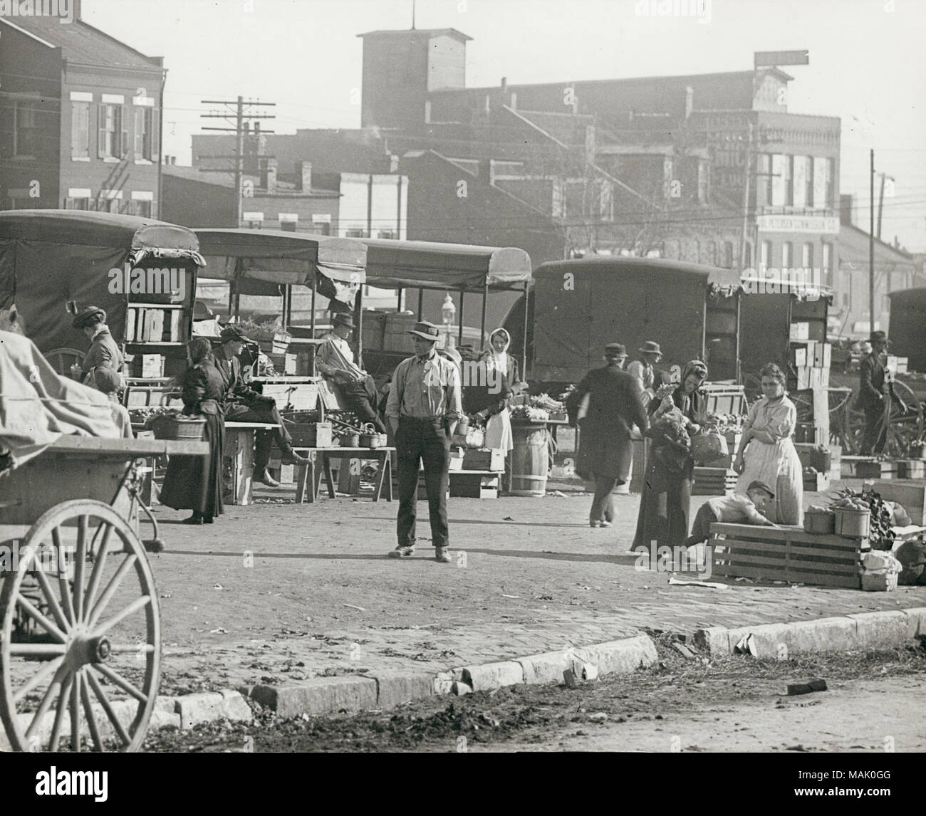 Horizontal, black and white photograph of market stalls and people ...