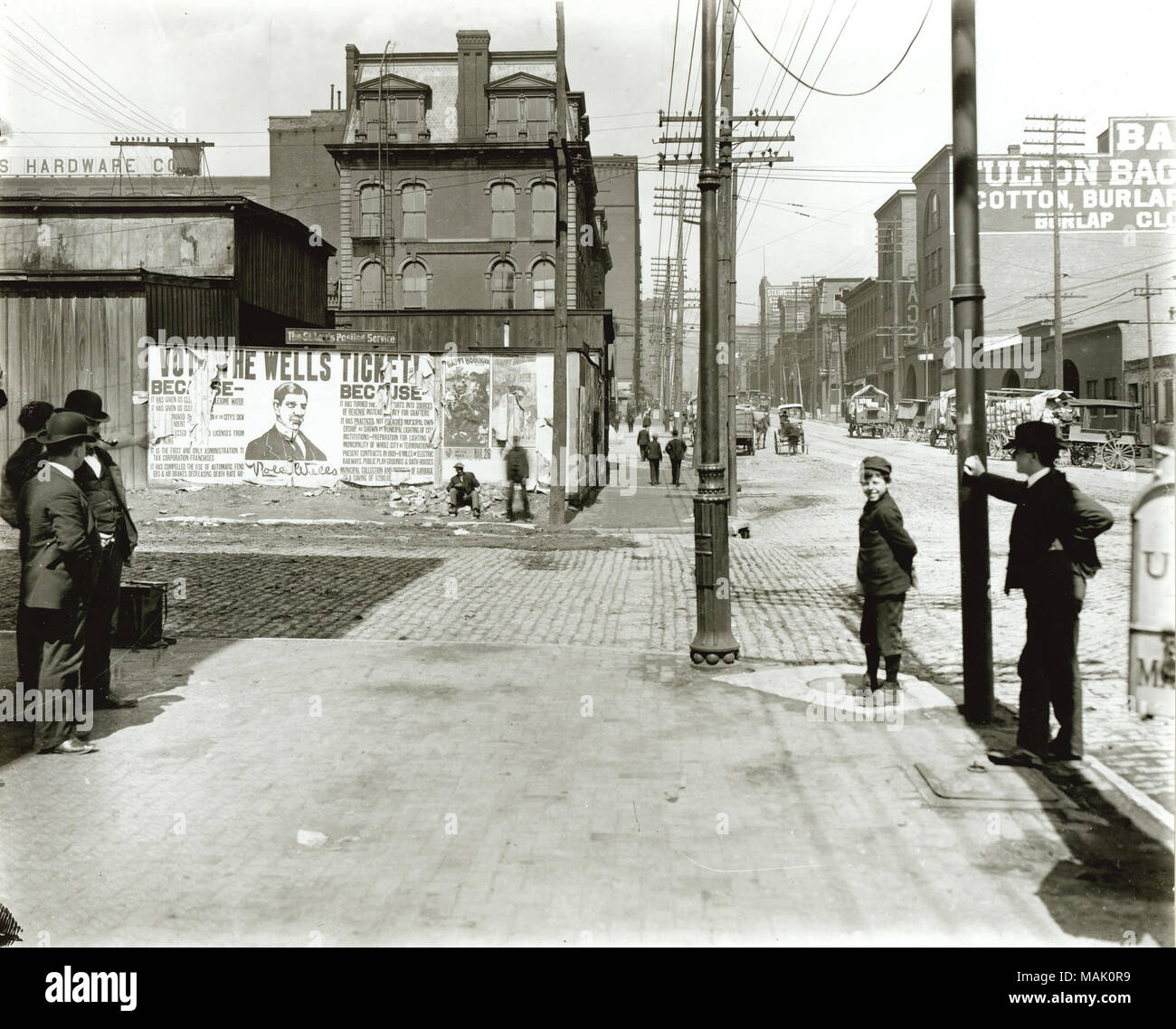 View of Seventh Street looking north toward Cerre Street. Men and children gathered along Seventh Street looking north toward Cerre Street. Advertising promotes the political campaign in support of Rolla Wells. Rolla Wells served as St. Louis ?s mayor from 1901-1909, including the 1904 Worlds Fair. Wells ran on the platform of ?ǣNew St. Louis ? targeting some the cities infrastructure problems, including cleaner drinking water, cleaner air, greener public spaces and public bath houses. After his two terms of mayor, Wells held other civic offices including positions at the Federal Reserve Bank, Stock Photo