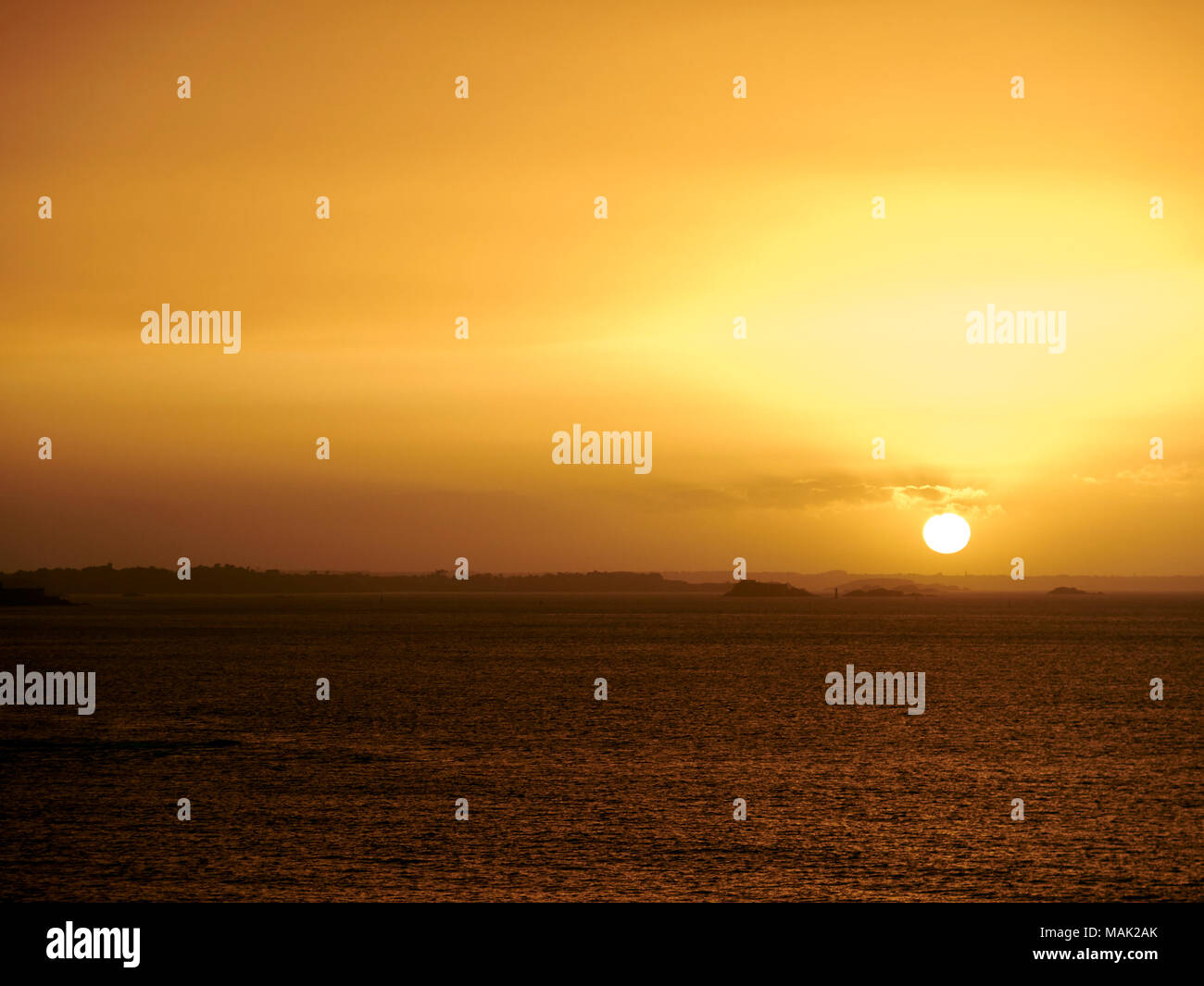 Image of Sunset over the sea, St Malo, France, Dust in the air. Stock Photo