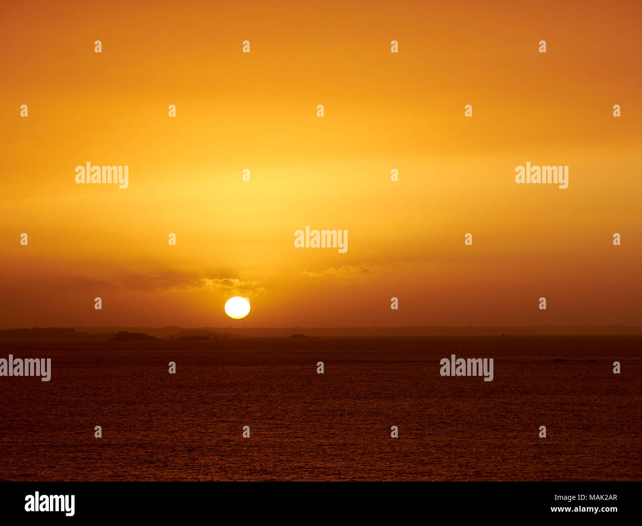 Image of Sunset over the sea, St Malo, France, Dust in the air. Stock Photo