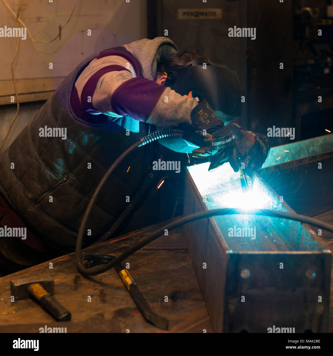 Welder arc welding steel frame Stock Photo
