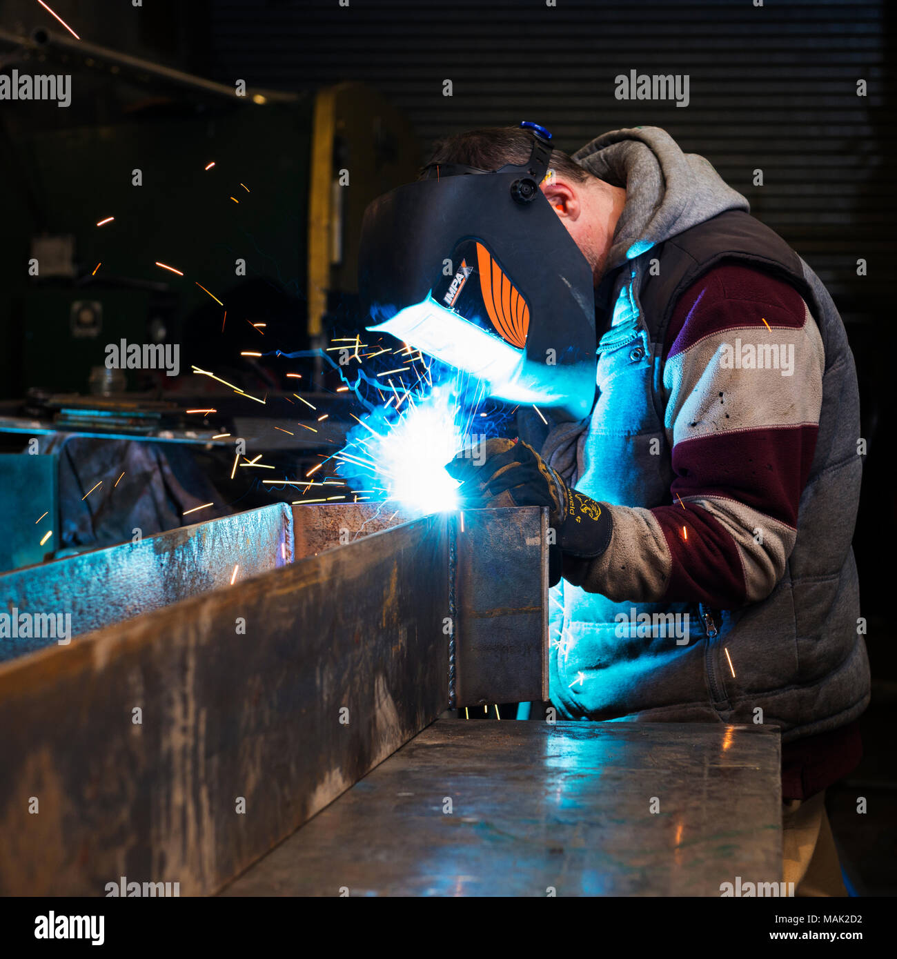 Welder arc welding steel frame Stock Photo