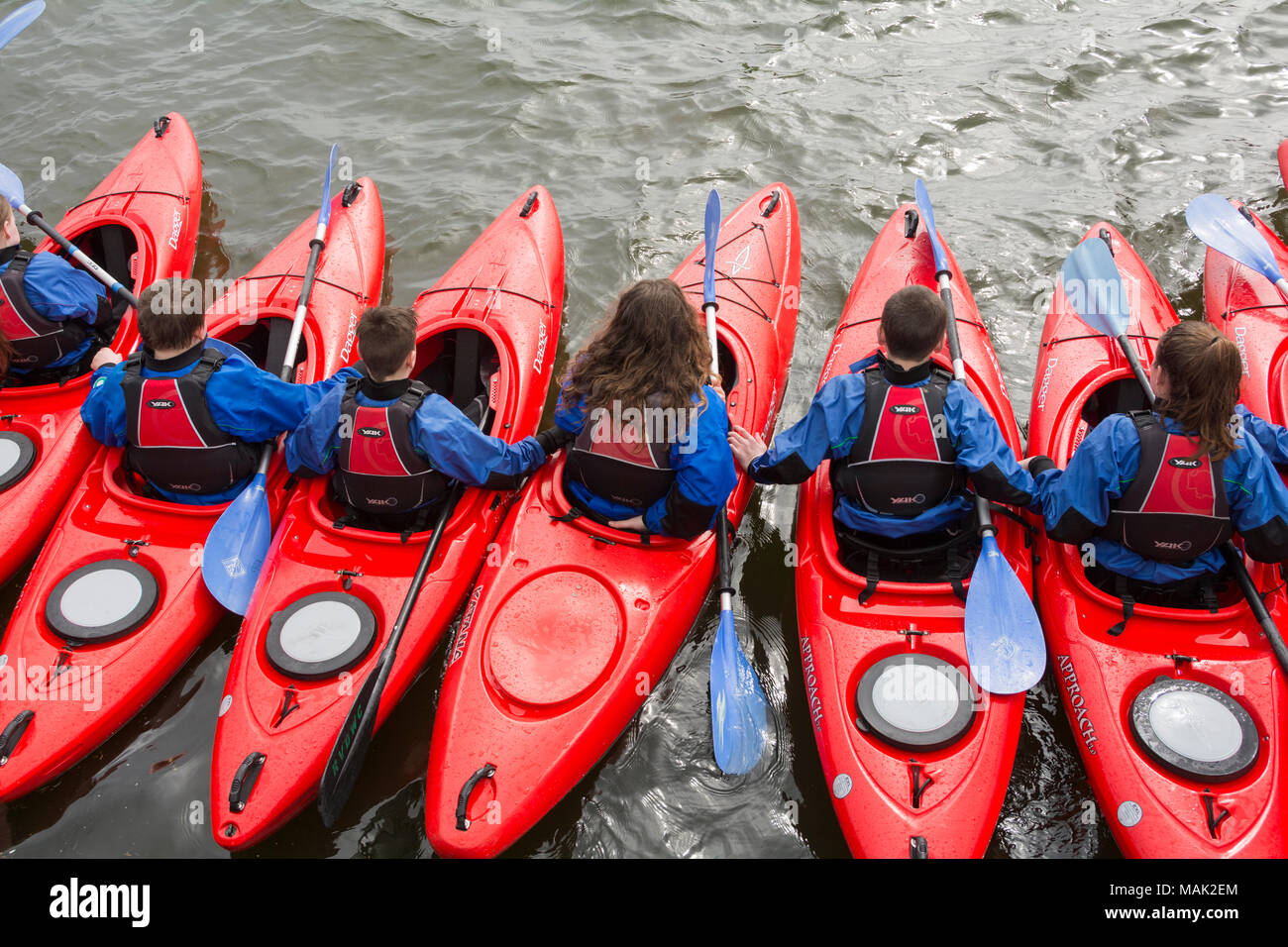 School children enjoying a kayak lesson on the Royal Albert Docks in London docklands, Newham, London, UK Stock Photo