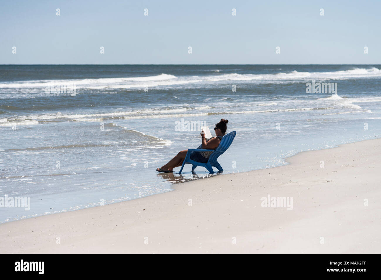 A Woman Reading A Book On New Smyrna Beach Florida Usa Stock Photo Alamy