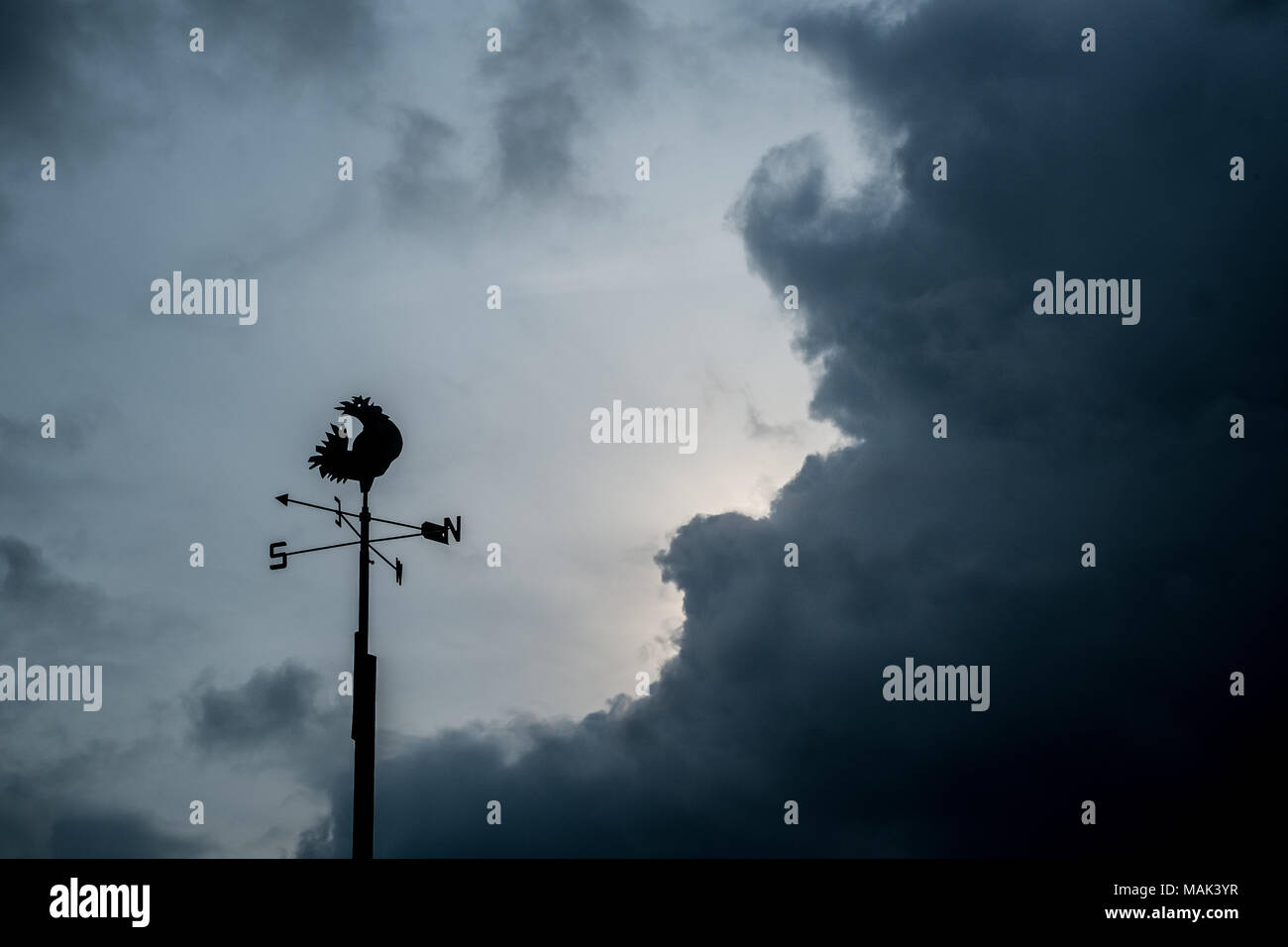 Weathercock in the clouds, Thorpeness, Suffolk Stock Photo