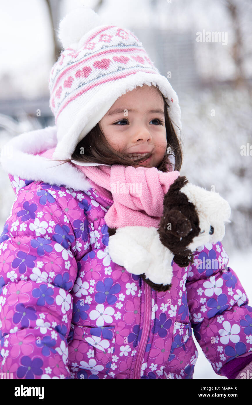 Toddler playing in a snow day Stock Photo