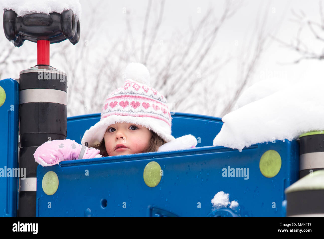 Toddler playing in a snow day Stock Photo