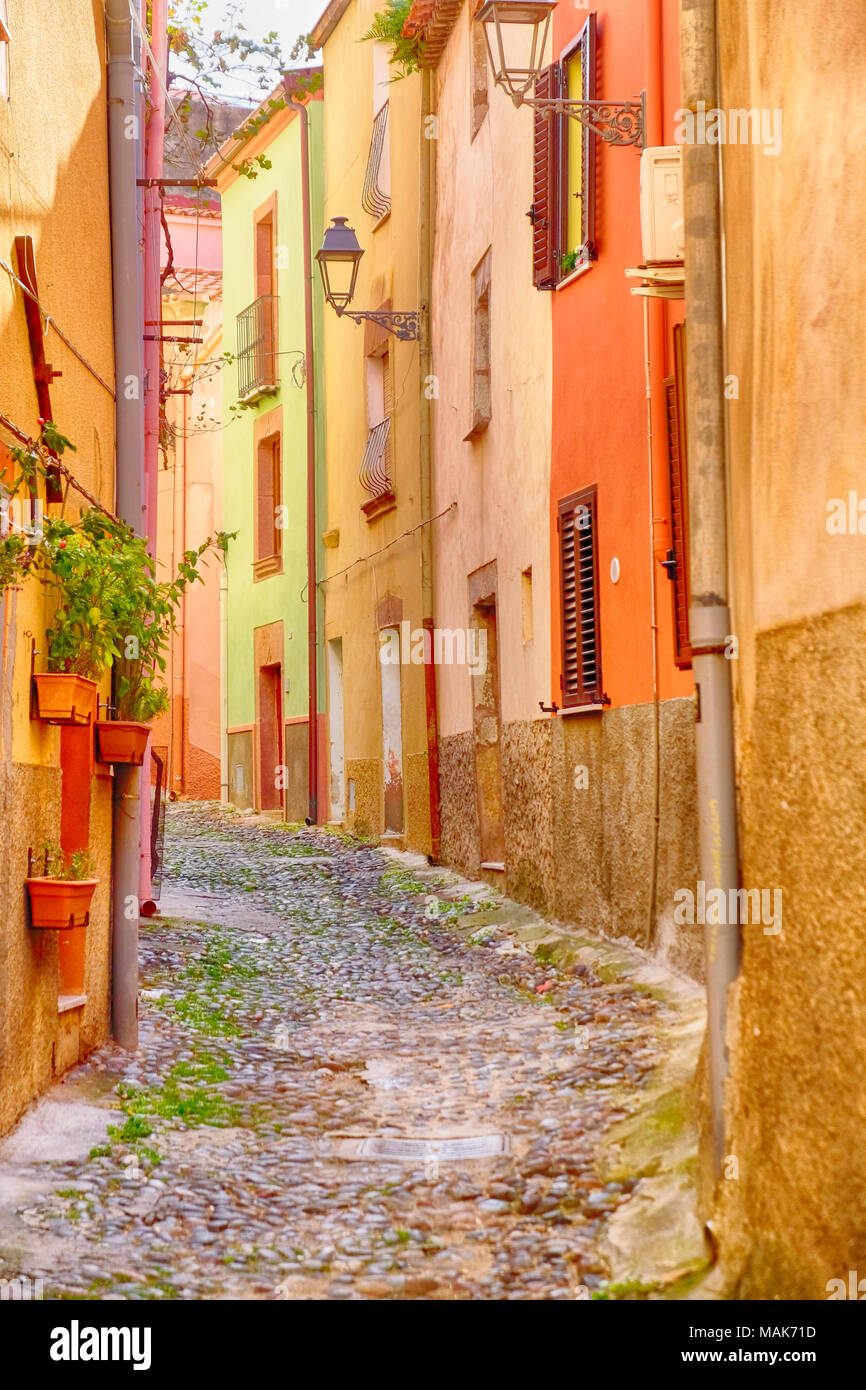 Colorful street decorated with pots and plants in Bosa old town, Sardinia, Italy Stock Photo