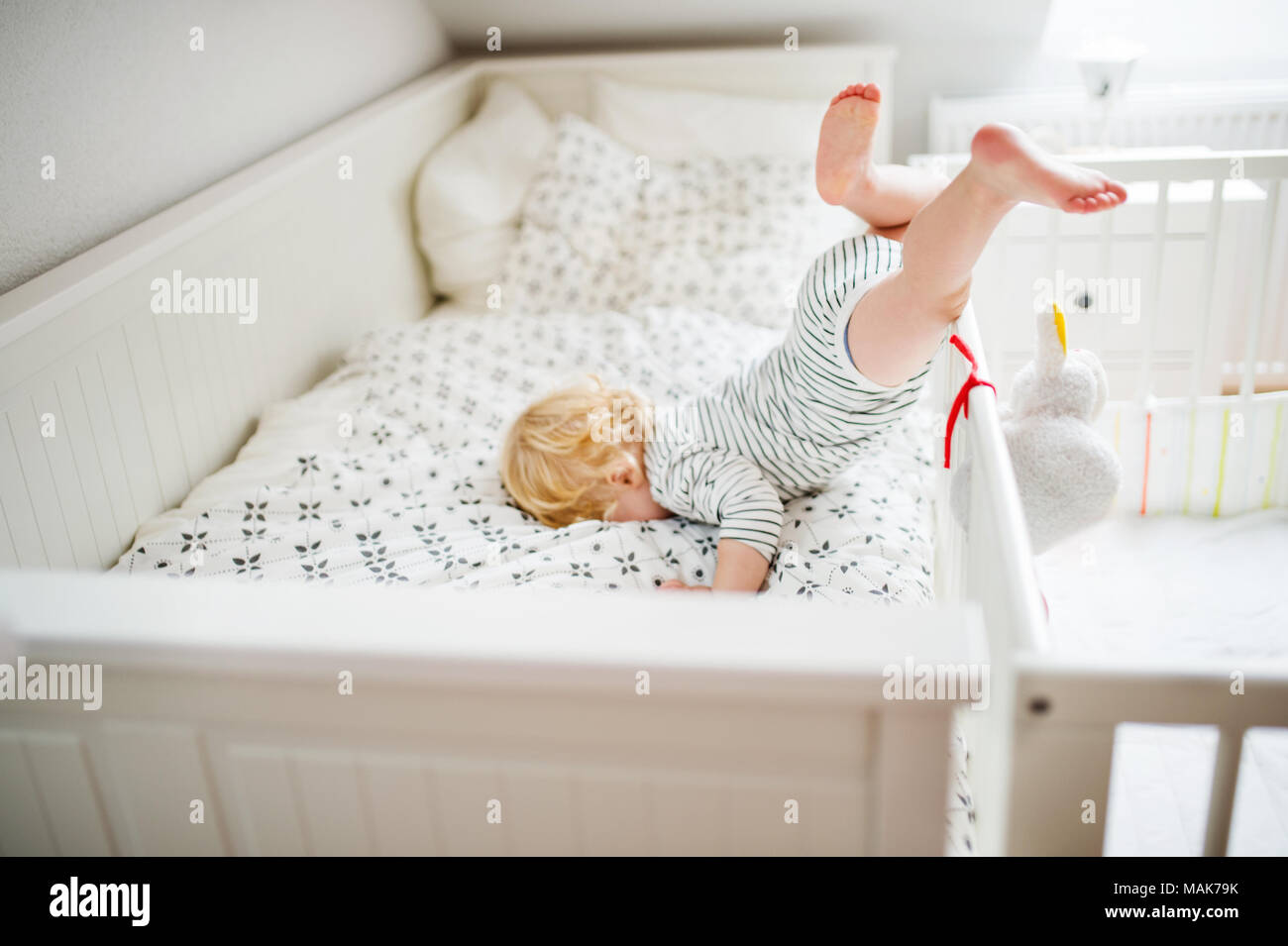 Toddler boy in a dangerous situation at home. Stock Photo