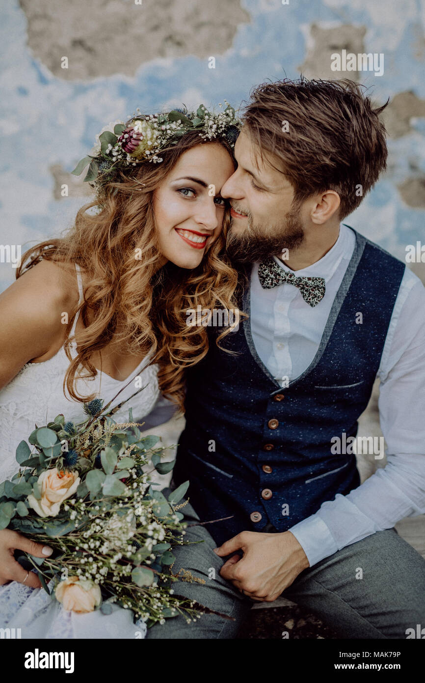 Beautiful bride and groom in front of old shabby house Stock Photo - Alamy