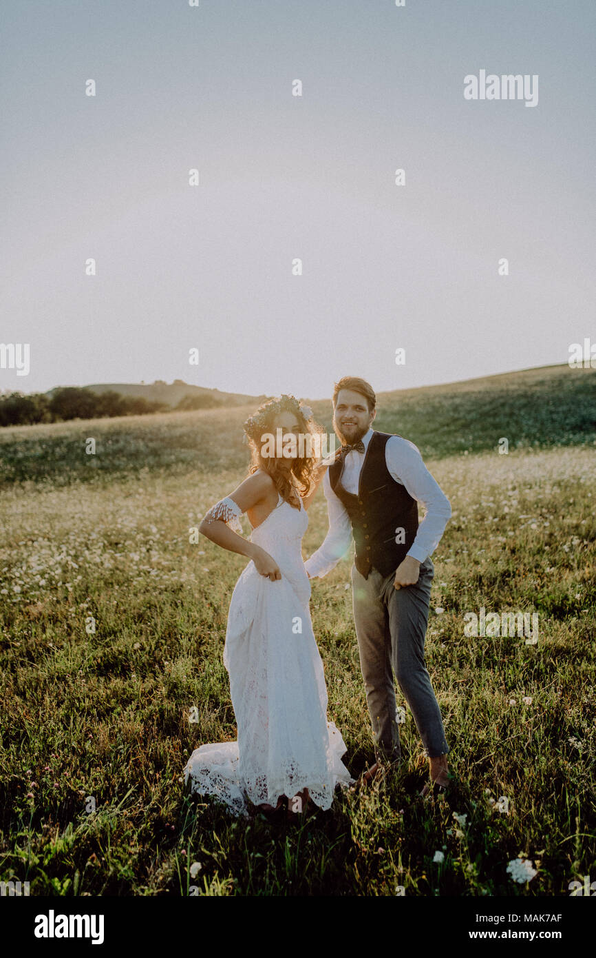 Beautiful bride and groom at sunset in green nature Stock Photo - Alamy