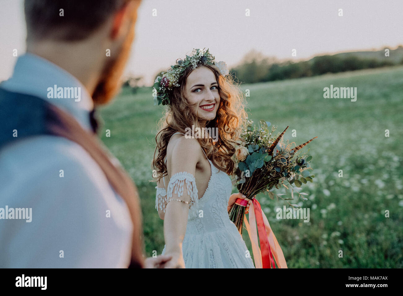 Beautiful bride and groom at sunset in green nature Stock Photo - Alamy