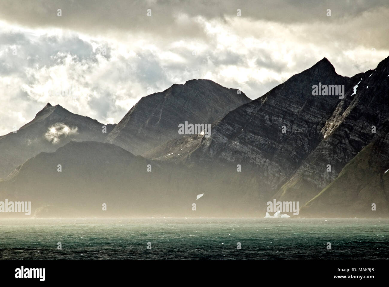 Dramatic sky in early morning light over the mountains of South Georgia Antarctica Stock Photo