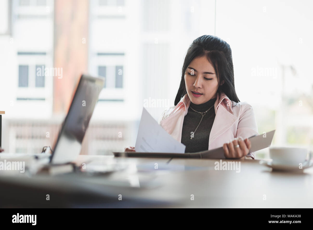 Young Asian executive female manage paperwork in meeting room. Business people lifestyle on workday Stock Photo