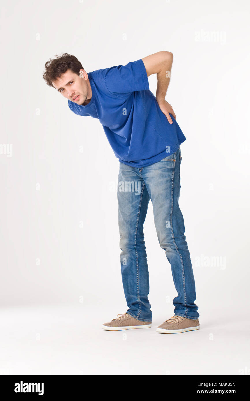 Boy in blue T-shirt and jeans having hurt the back Stock Photo