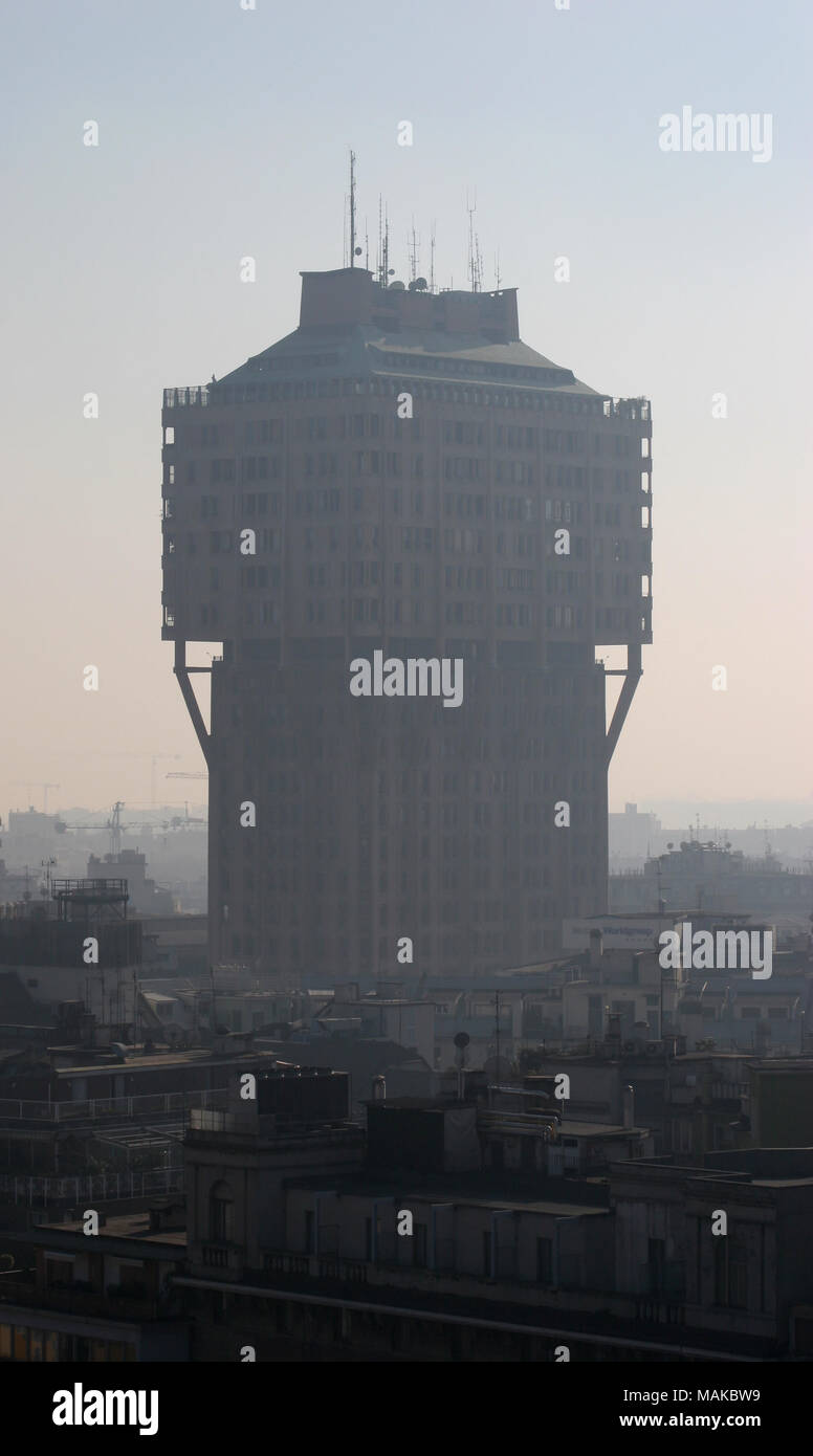 Torre Velasca or Velasca Tower seen through bad air pollution, smog or traffic fumes visible on the Milan city skyline. Polluted poor air quality. Stock Photo