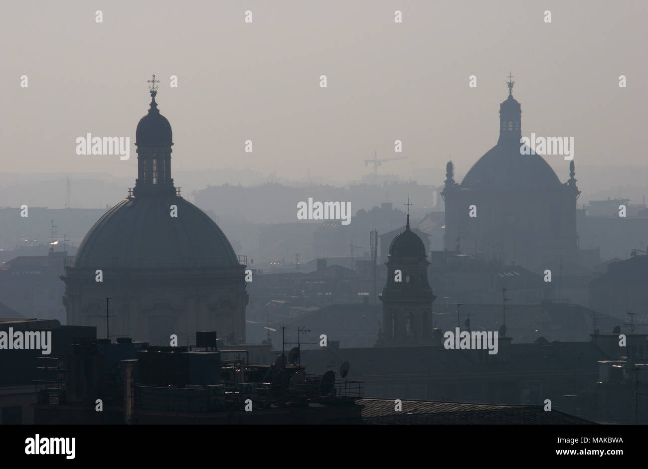Terrible air pollution or smog from traffic fumes visible on the Milan city skyline. Polluted poor air quality. Stock Photo