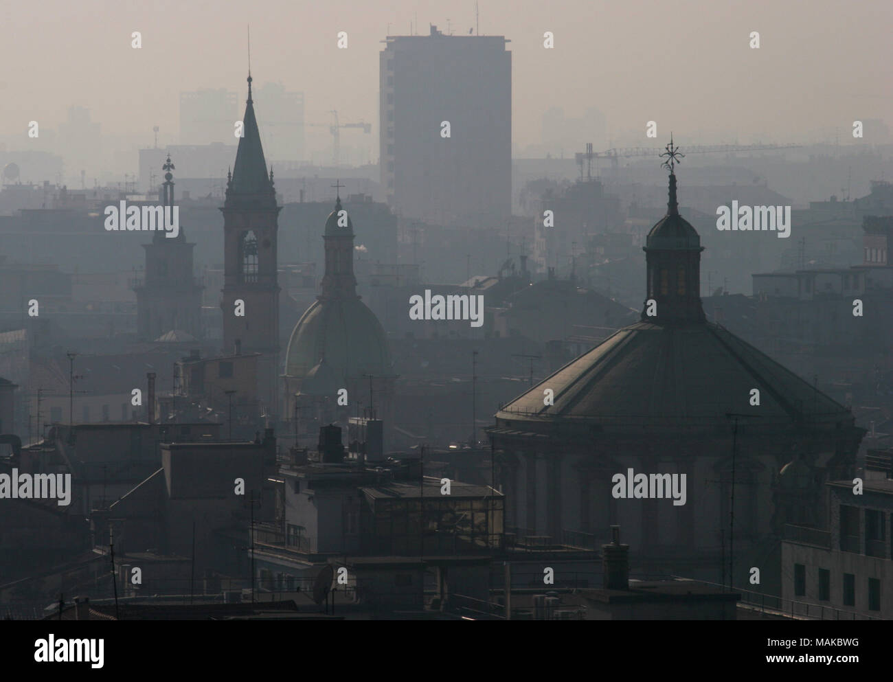 Terrible air pollution or smog from traffic fumes visible on the Milan city skyline. Polluted poor air quality. Stock Photo