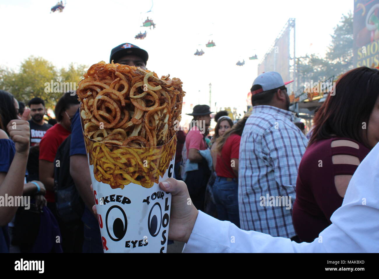 a huge portion of fries chips in a cone shaped container at houston