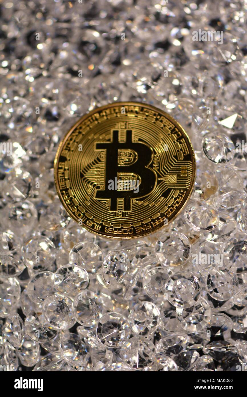 Bit coins with silver dollars and diamonds. Stock Photo