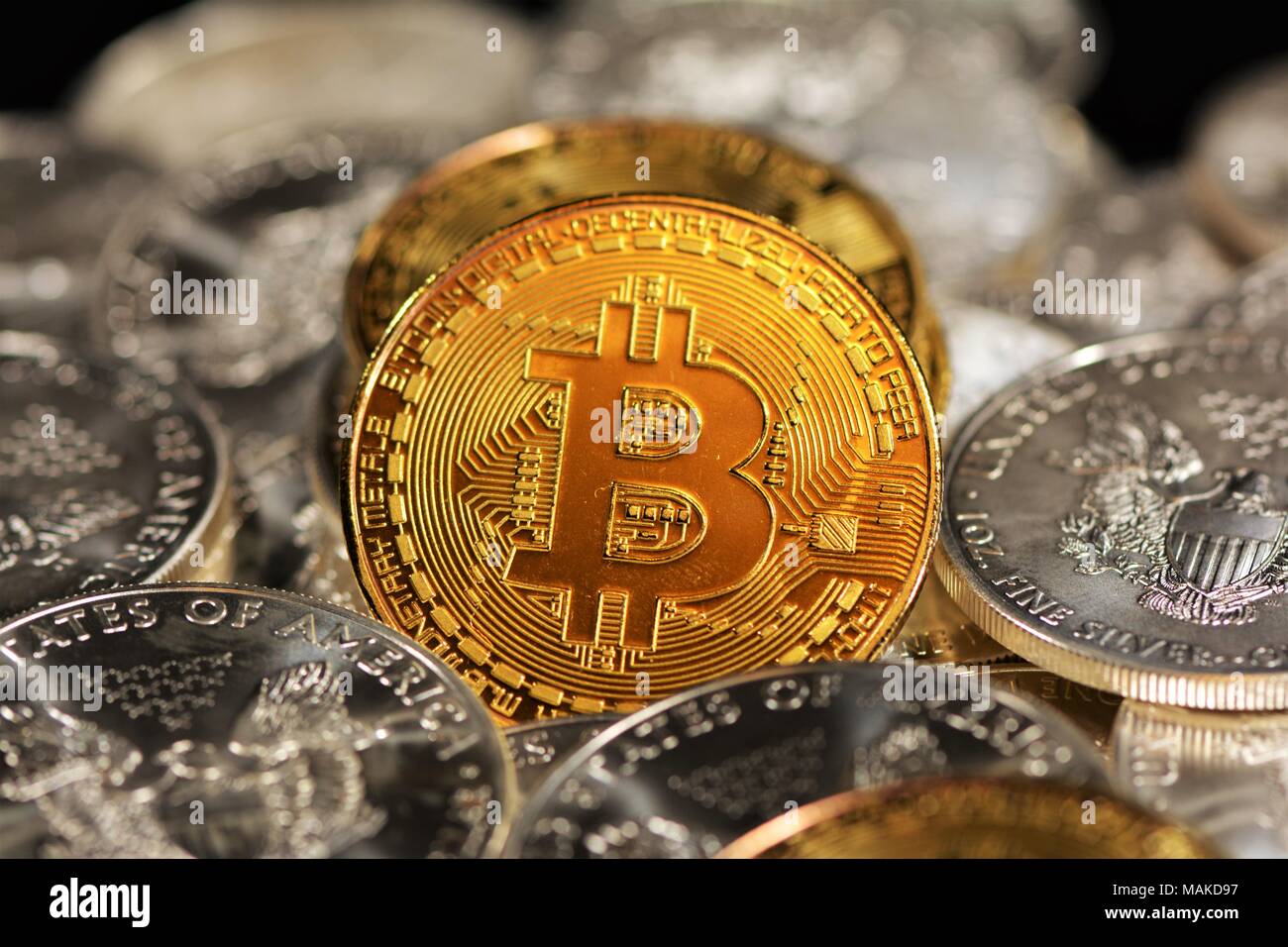 Bit coins with silver dollars and diamonds. Stock Photo