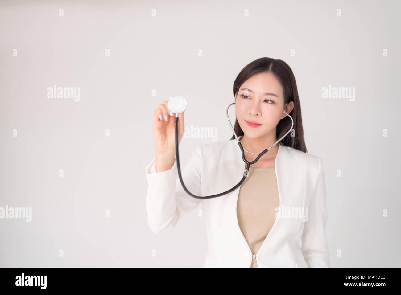 Medical, treatment, doctor, clinical, hospital, diagnosis, health checkup concept. Beautiful asian woman female doctor holding sthetoscope isolated on Stock Photo