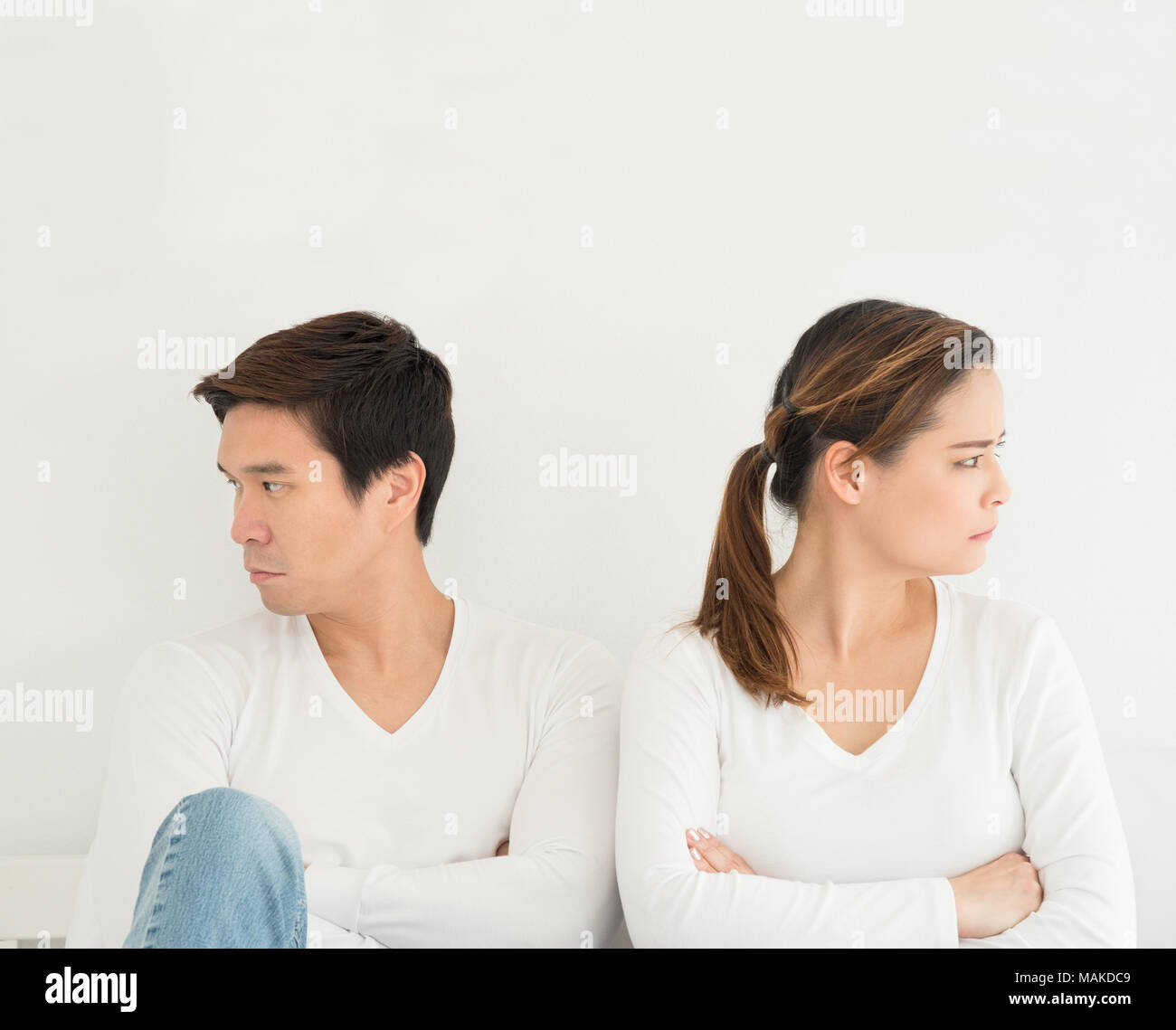 Asian lover or love couple break up divorce concept, lover turn back each other on the bed with white background with copy space, Family or relationsh Stock Photo
