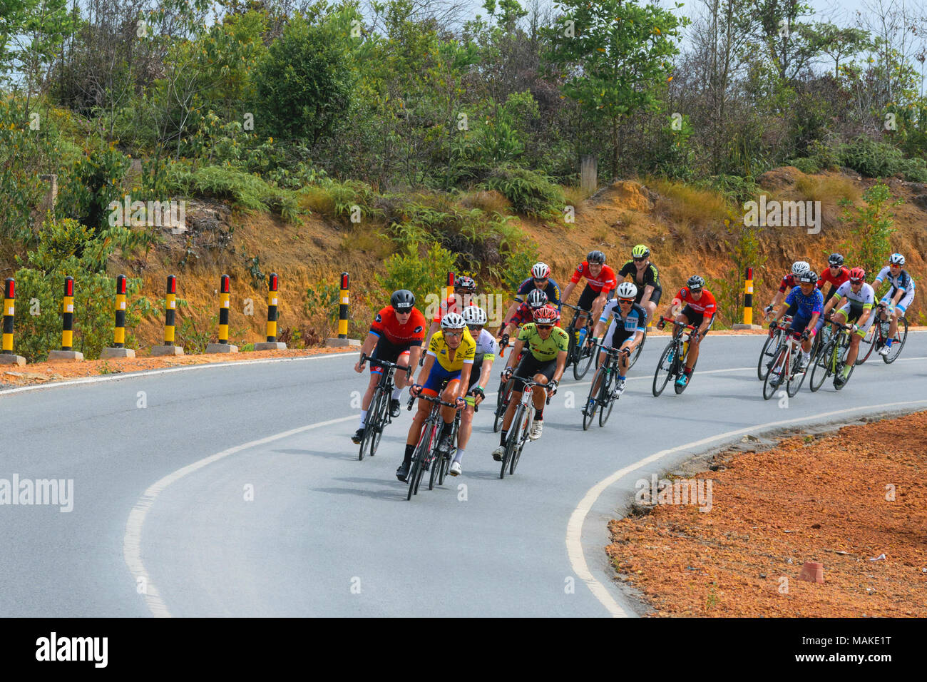 march 24, 2018 - cyclists participants Tour de bintan 2018 (144 km) are crossing the plantations Toapaya and Galang batang, bintan island - Indonesia Stock Photo