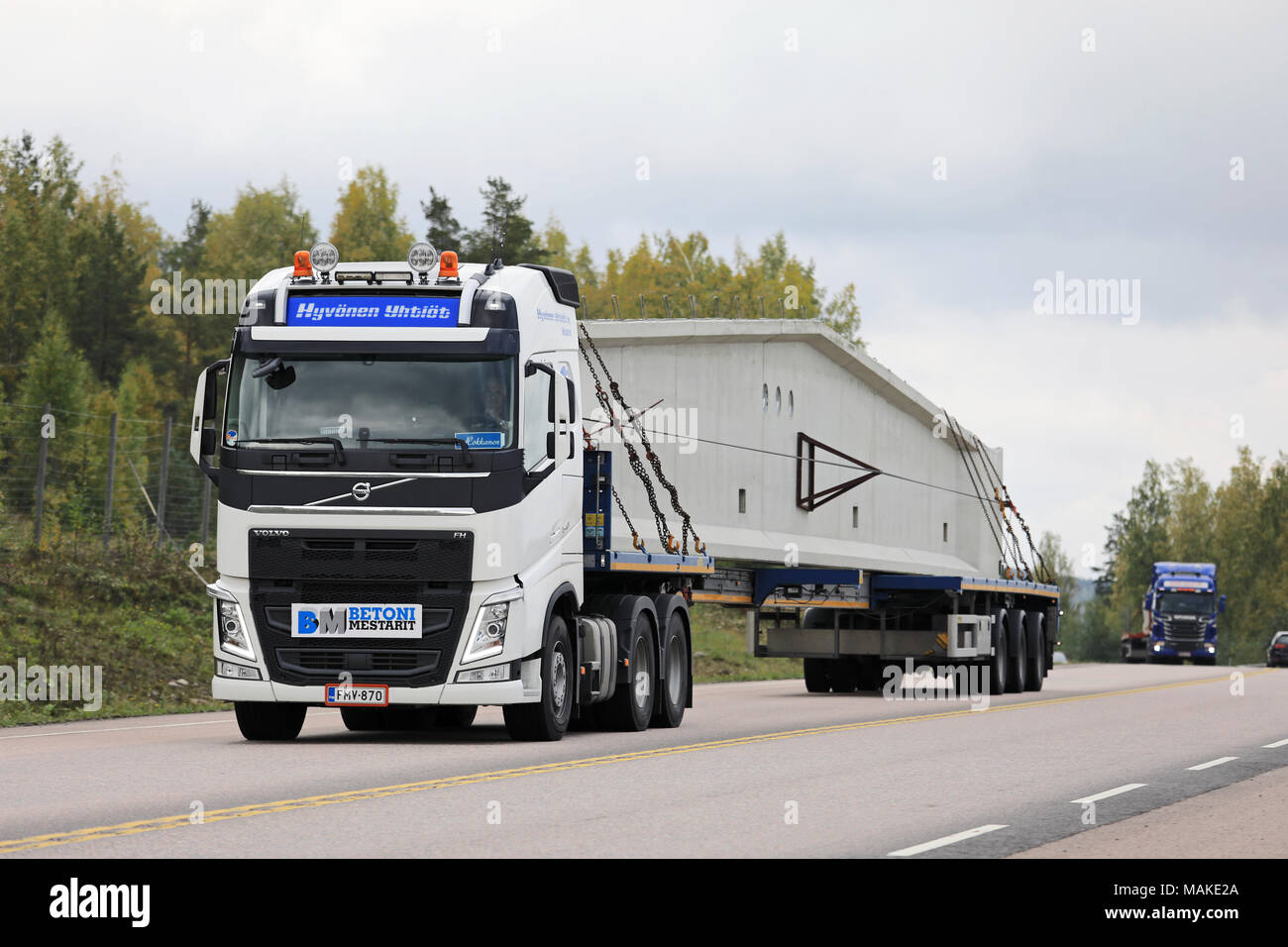 ORIVESI, FINLAND - SEPTEMBER 21, 2017: Volvo FH 540 semi trailer of Hyvonen Yhtiöt transports long precast concrete construction element in convoy alo Stock Photo